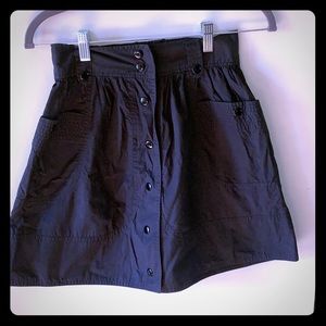 Snap front high-waisted skirt with pockets.